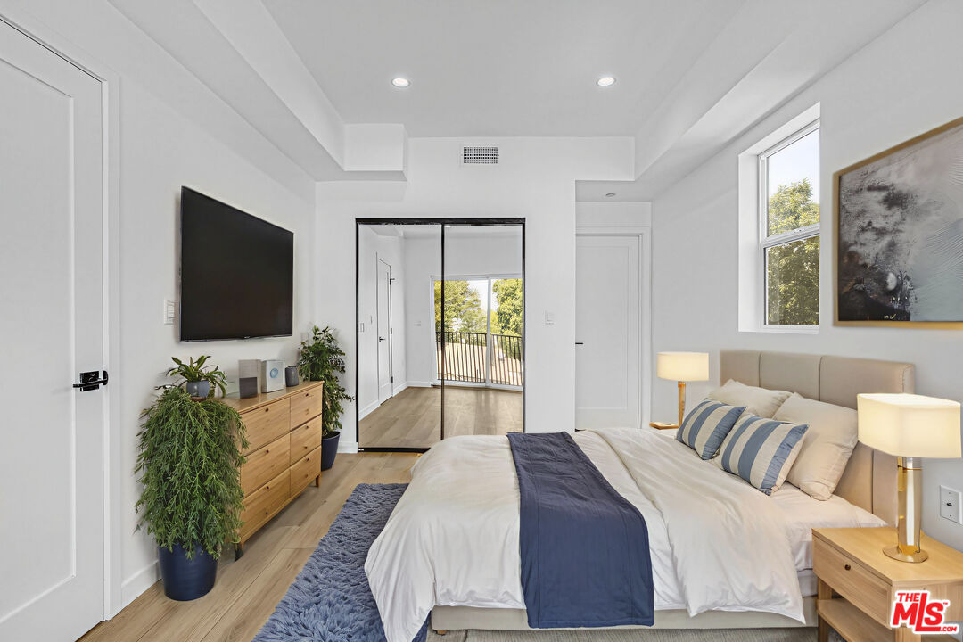 10828 Hesby Street North Hollywood, CA 91601 - Photo 5 of 33 a bedroom with a bed and a flat screen television