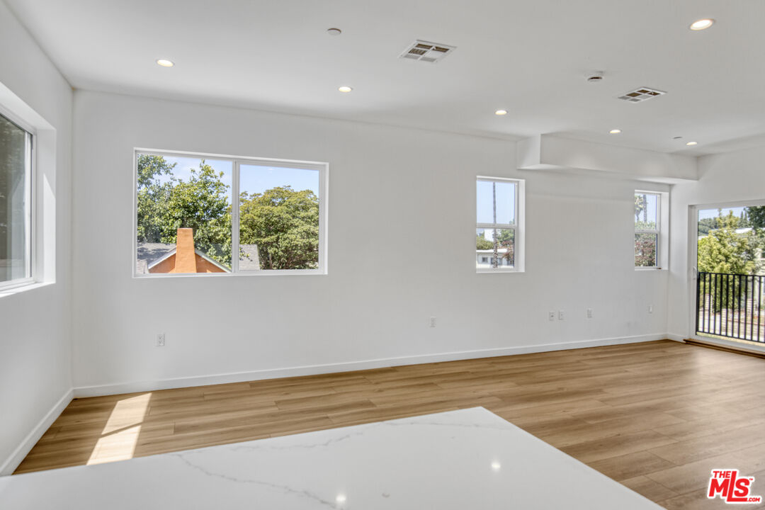 10828 Hesby Street North Hollywood, CA 91601 - Photo 6 of 33 an empty room with wooden floor and windows