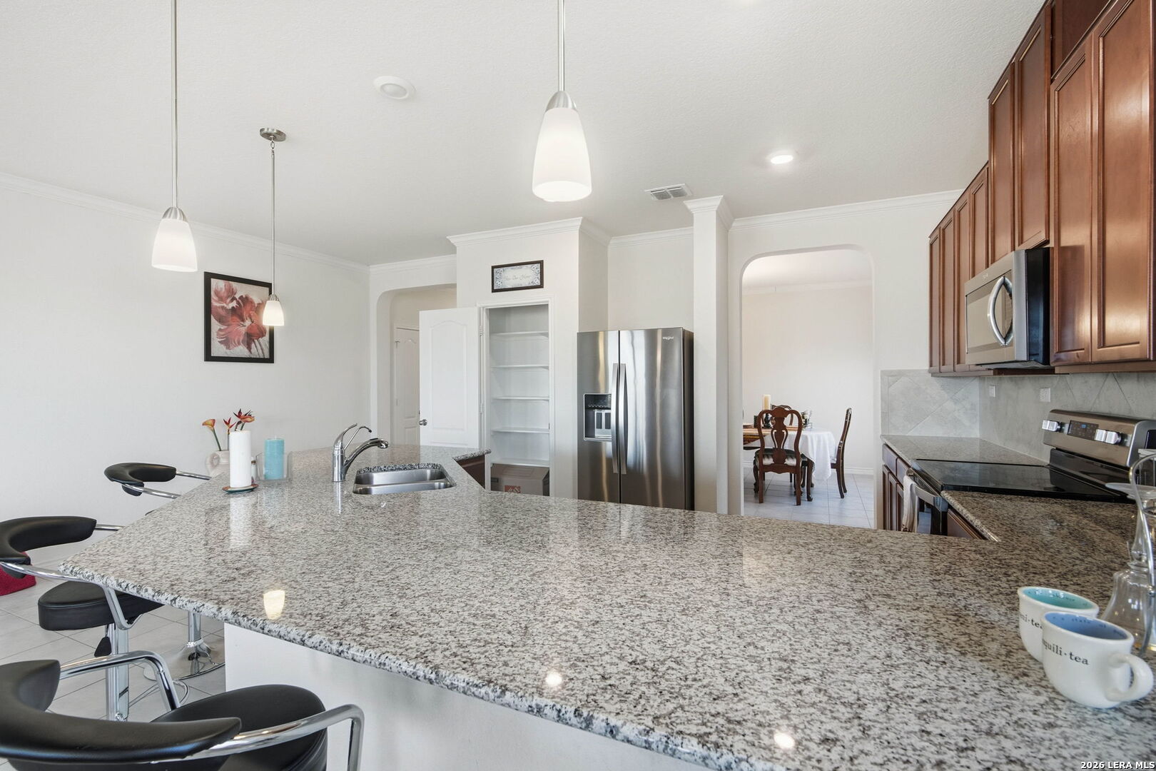5103 Devanado Way San Antonio, TX 78261 - Photo 14 of 42 a kitchen with stainless steel appliances granite countertop a sink refrigerator and cabinets