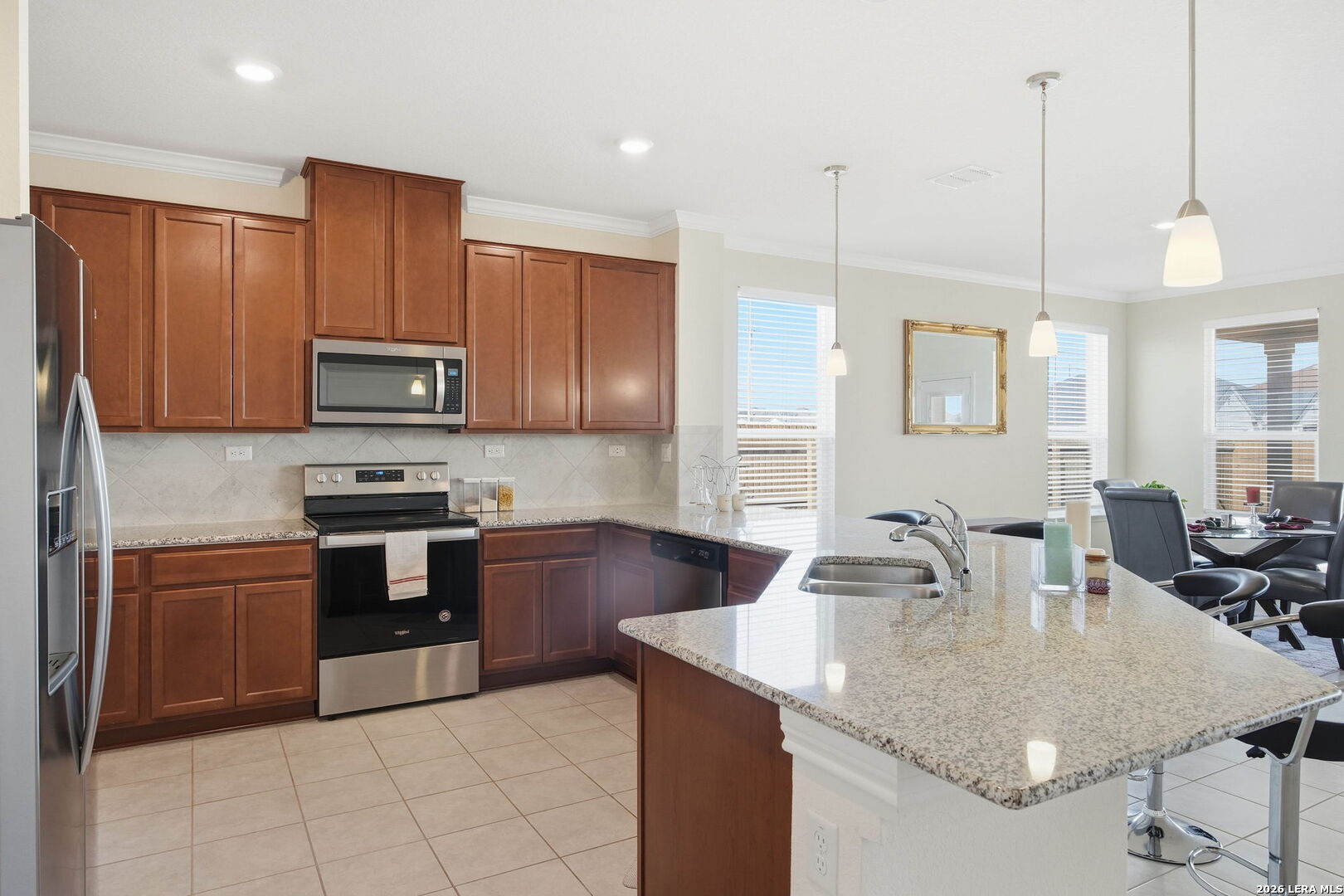 5103 Devanado Way San Antonio, TX 78261 - Photo 18 of 42 a kitchen with kitchen island granite countertop a sink counter top space appliances and cabinets