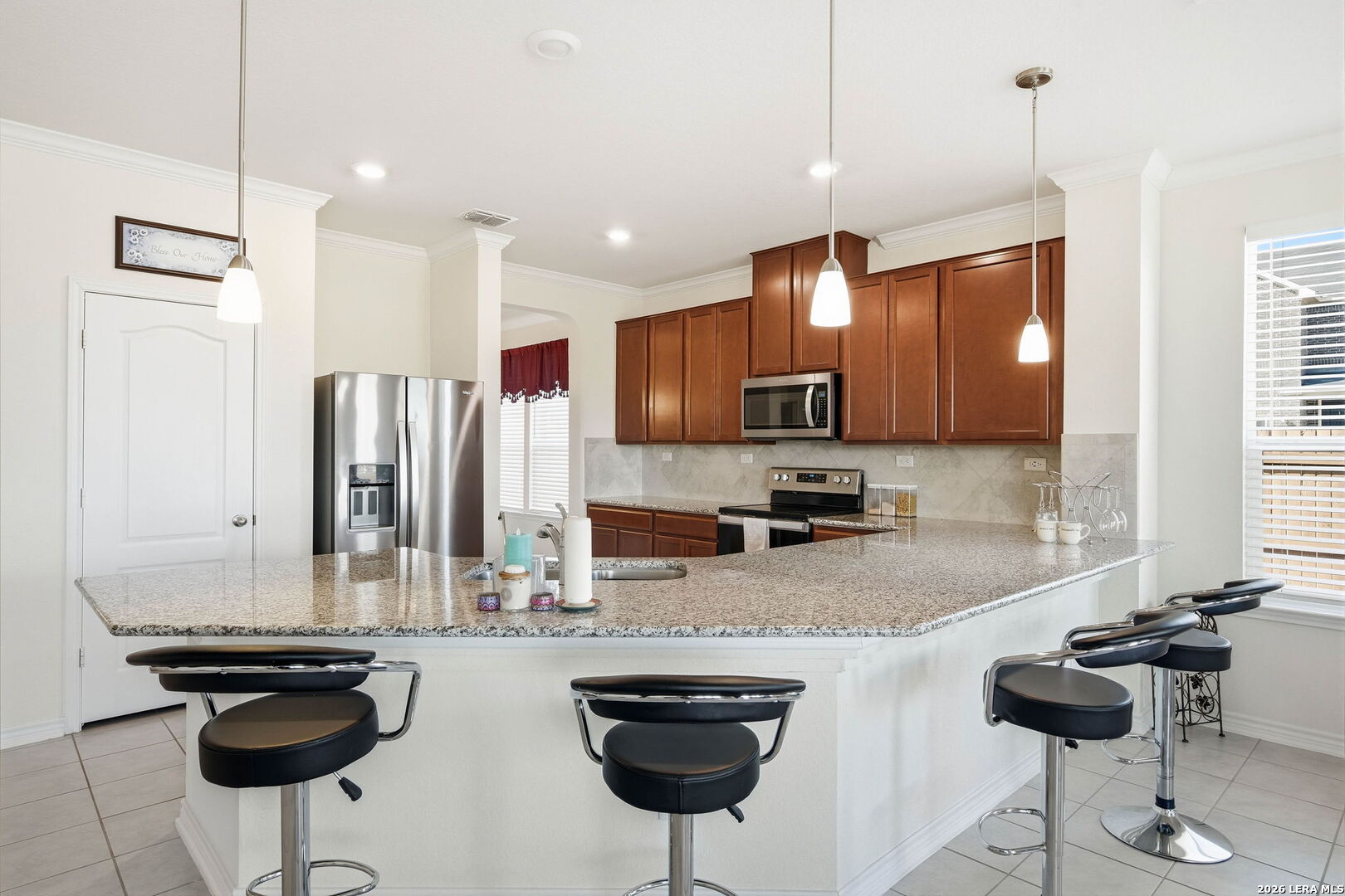 5103 Devanado Way San Antonio, TX 78261 - Photo 19 of 42 a kitchen with stainless steel appliances granite countertop a stove a sink and a refrigerator
