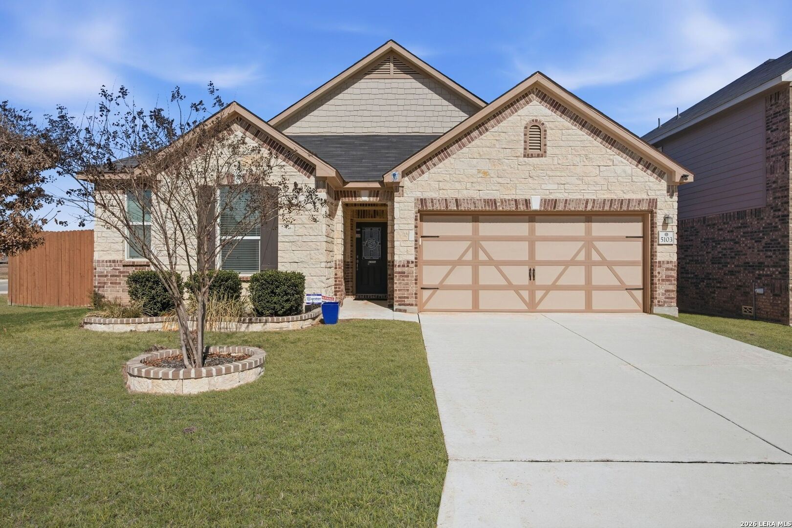 5103 Devanado Way San Antonio, TX 78261 - Photo 2 of 42 a front view of a house with a yard and a garage