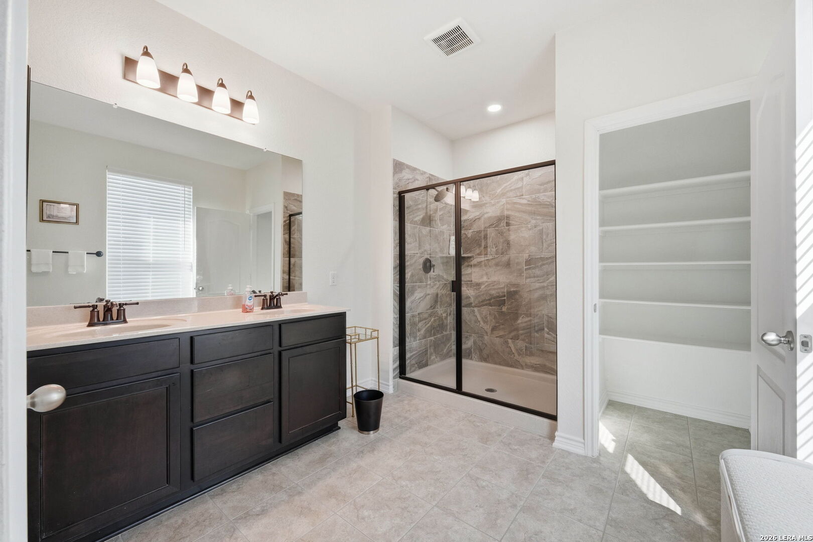 5103 Devanado Way San Antonio, TX 78261 - Photo 23 of 42 a spacious bathroom with a shower sink and mirror