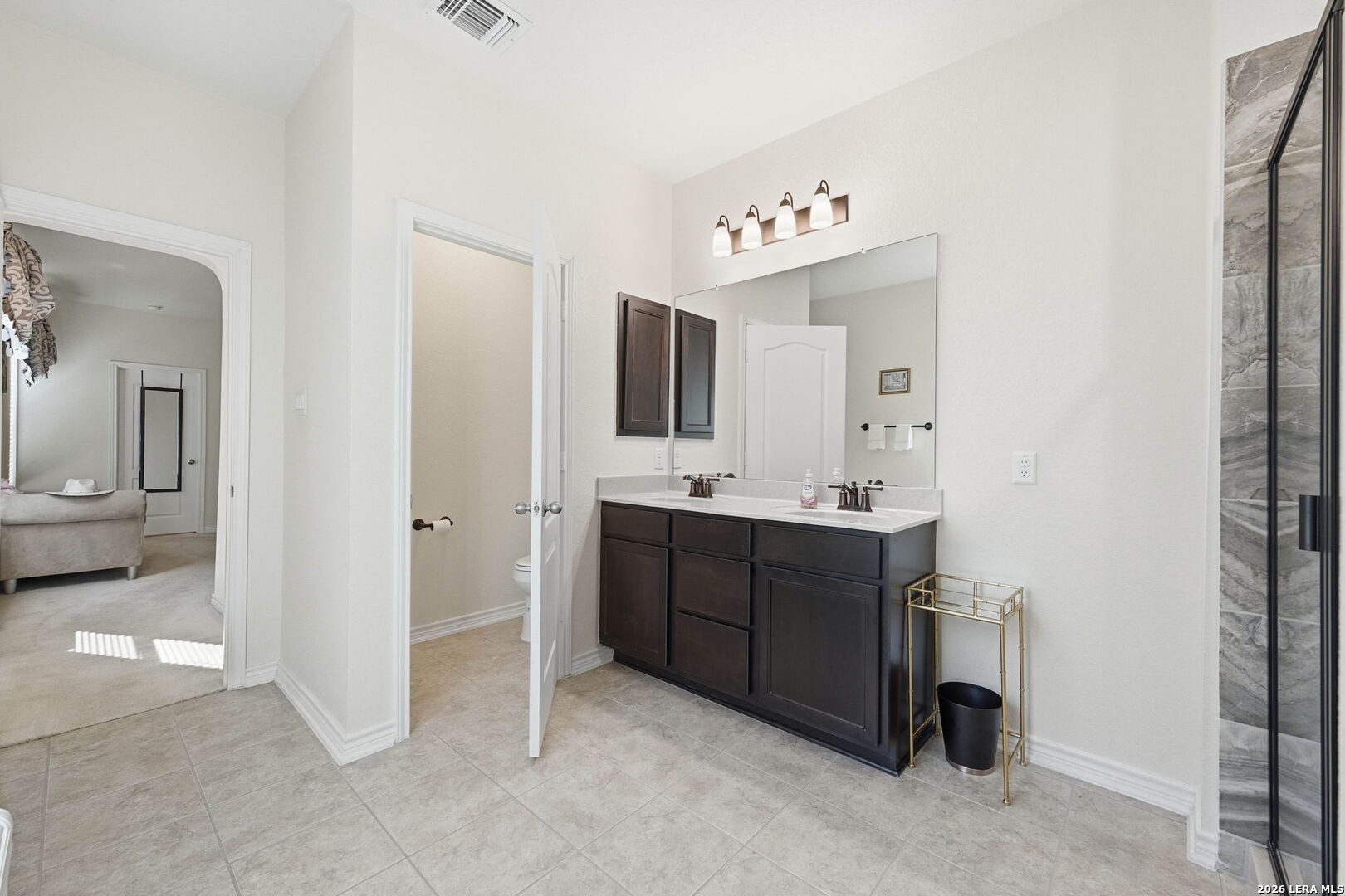 5103 Devanado Way San Antonio, TX 78261 - Photo 24 of 42 a spacious bathroom with a double vanity sink and mirror