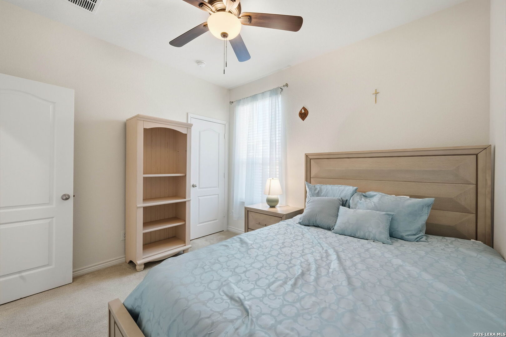 5103 Devanado Way San Antonio, TX 78261 - Photo 30 of 42 a bedroom with a bed and a chandelier