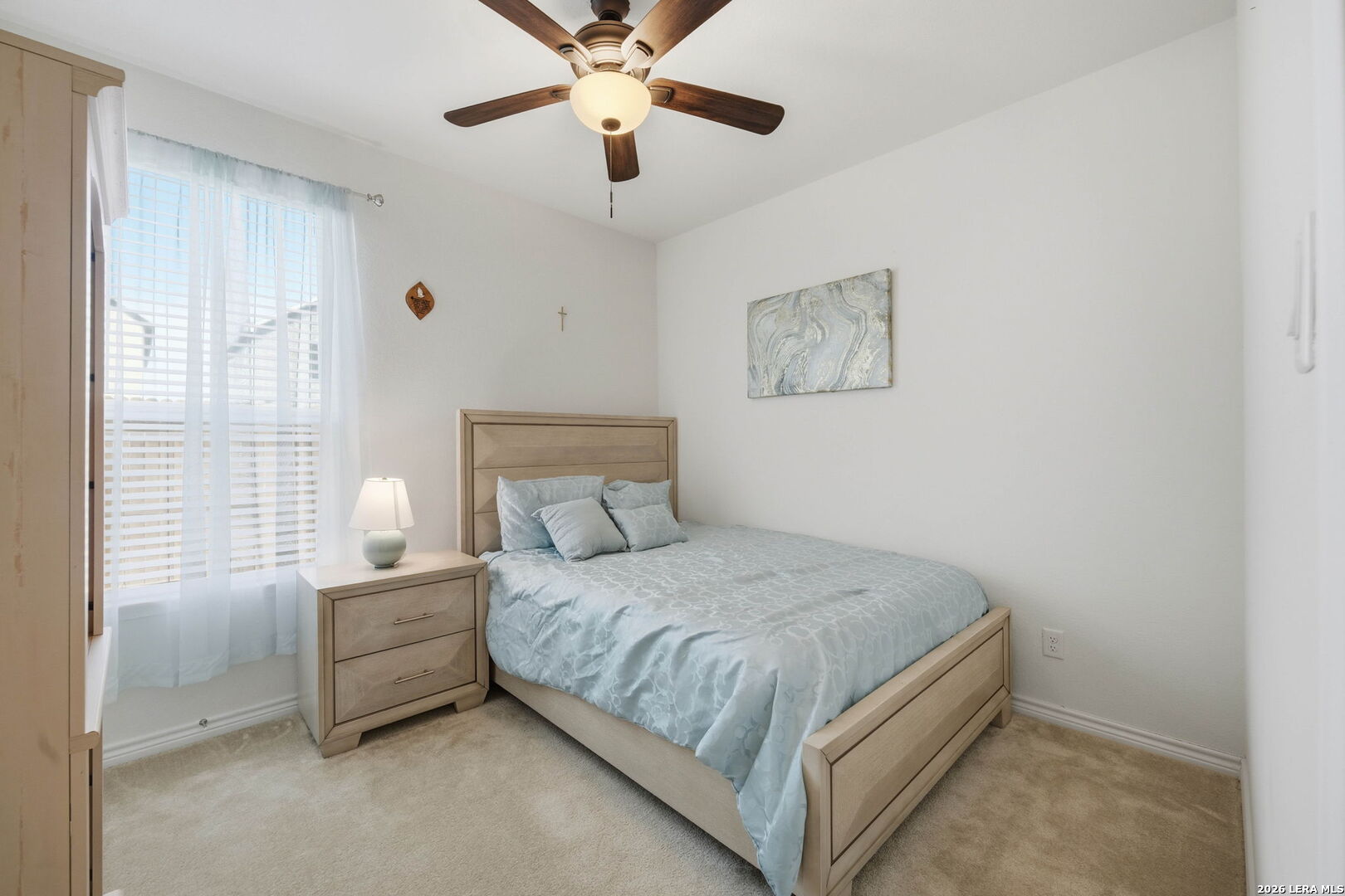 5103 Devanado Way San Antonio, TX 78261 - Photo 31 of 42 a bedroom with a bed and a chandelier