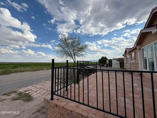 a bedroom with a bed window and mirror