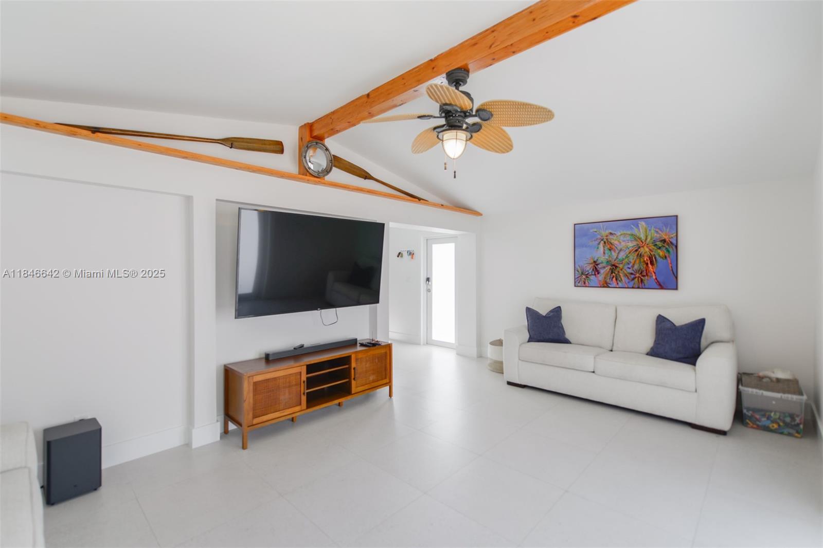 11 Mockingbird Road Key Largo, FL 33037 - Photo 11 of 44 a living room with furniture and a flat screen tv