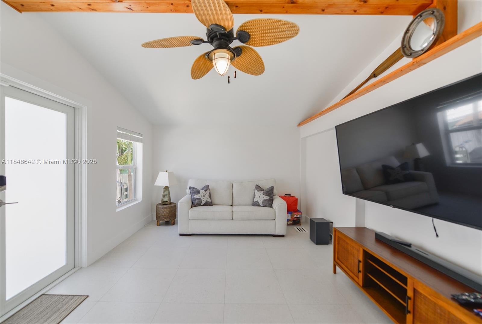 11 Mockingbird Road Key Largo, FL 33037 - Photo 12 of 44 a living room with furniture and a flat screen tv