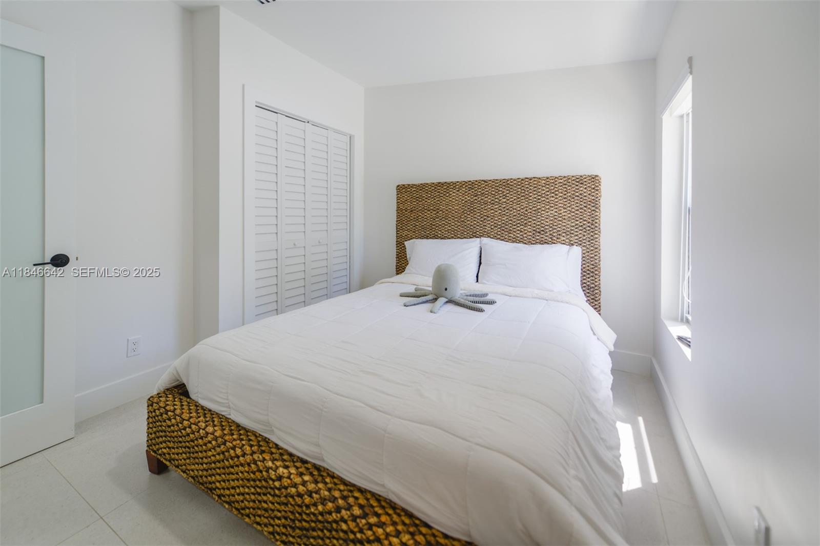 11 Mockingbird Road Key Largo, FL 33037 - Photo 16 of 44 a bedroom with a bed and a window