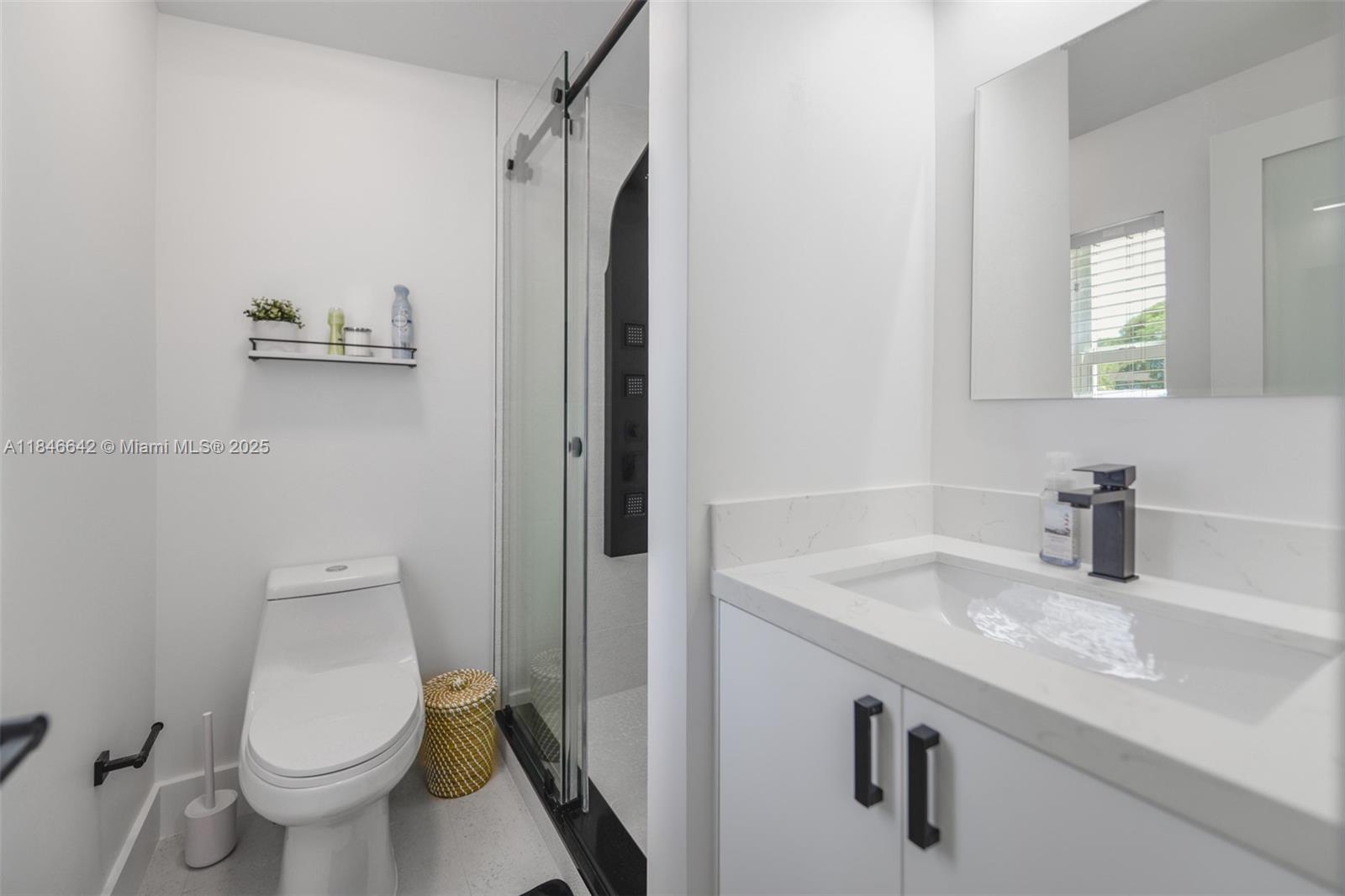11 Mockingbird Road Key Largo, FL 33037 - Photo 19 of 44 a bathroom with a granite countertop sink toilet and mirror