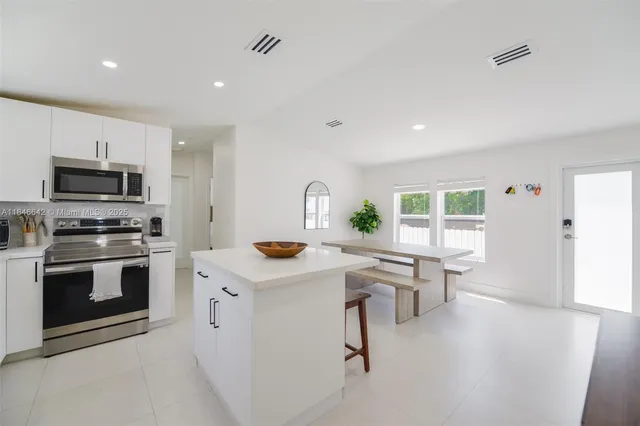 a kitchen with a sink a stove and cabinets