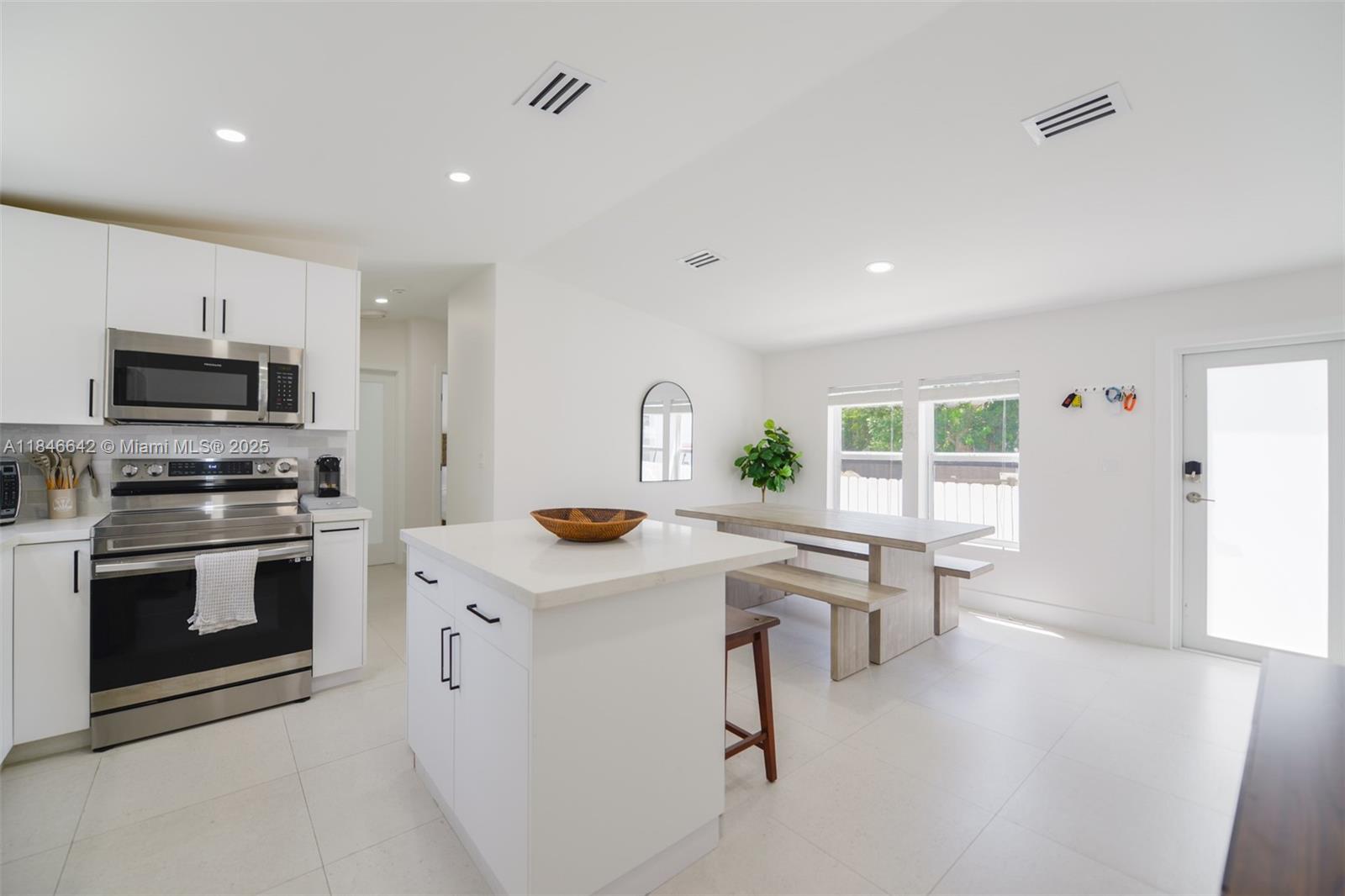 11 Mockingbird Road Key Largo, FL 33037 - Photo 2 of 44 a kitchen with a sink a stove and cabinets