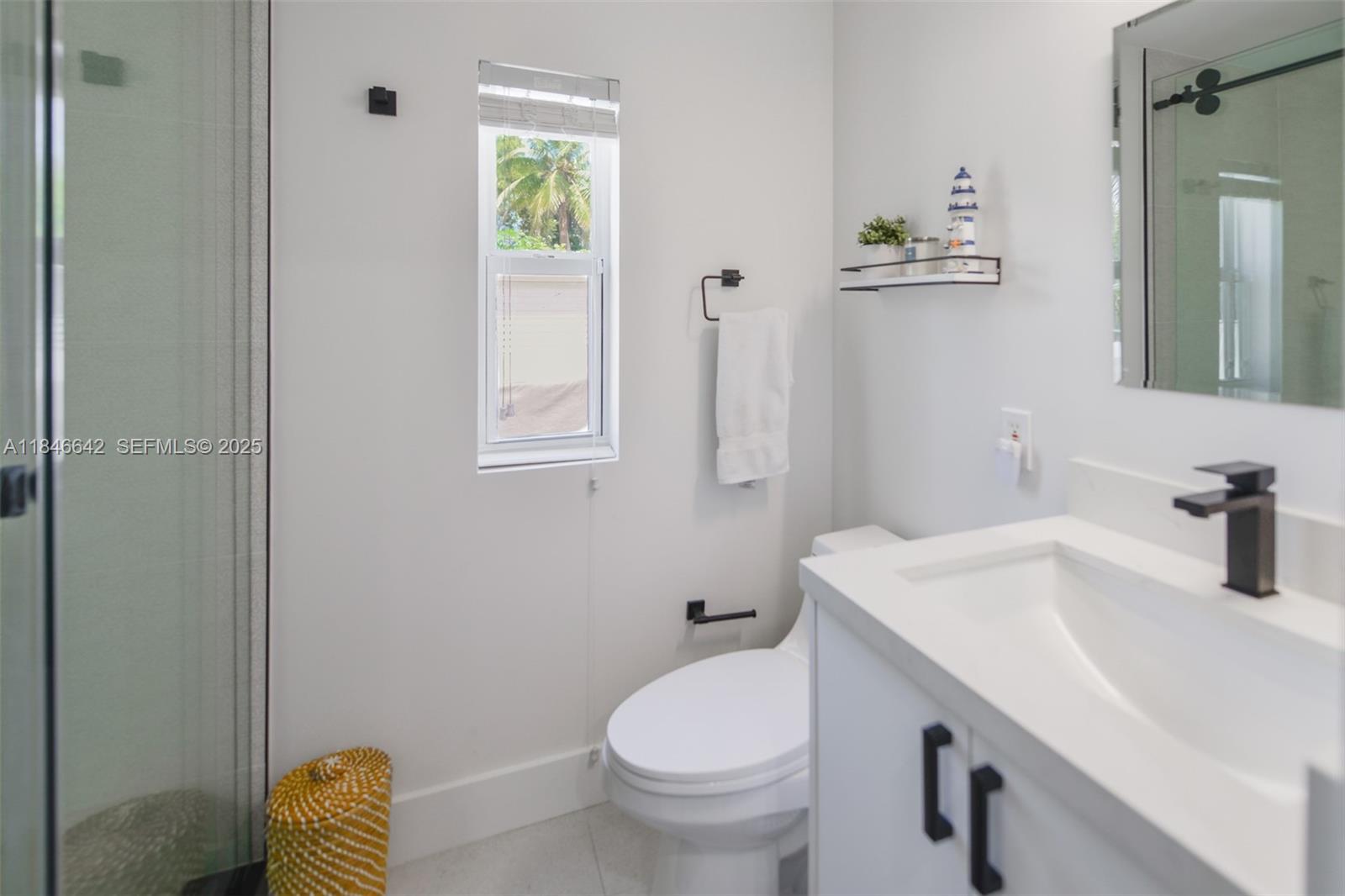 11 Mockingbird Road Key Largo, FL 33037 - Photo 25 of 44 a bathroom with a sink toilet and a mirror