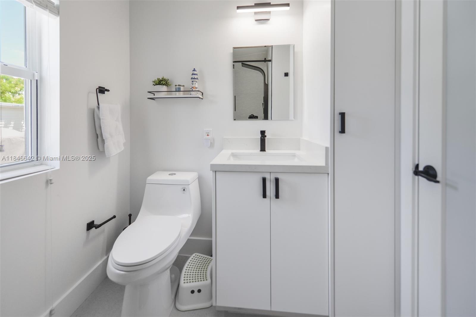 11 Mockingbird Road Key Largo, FL 33037 - Photo 26 of 44 a white toilet sitting next to a bathroom sink