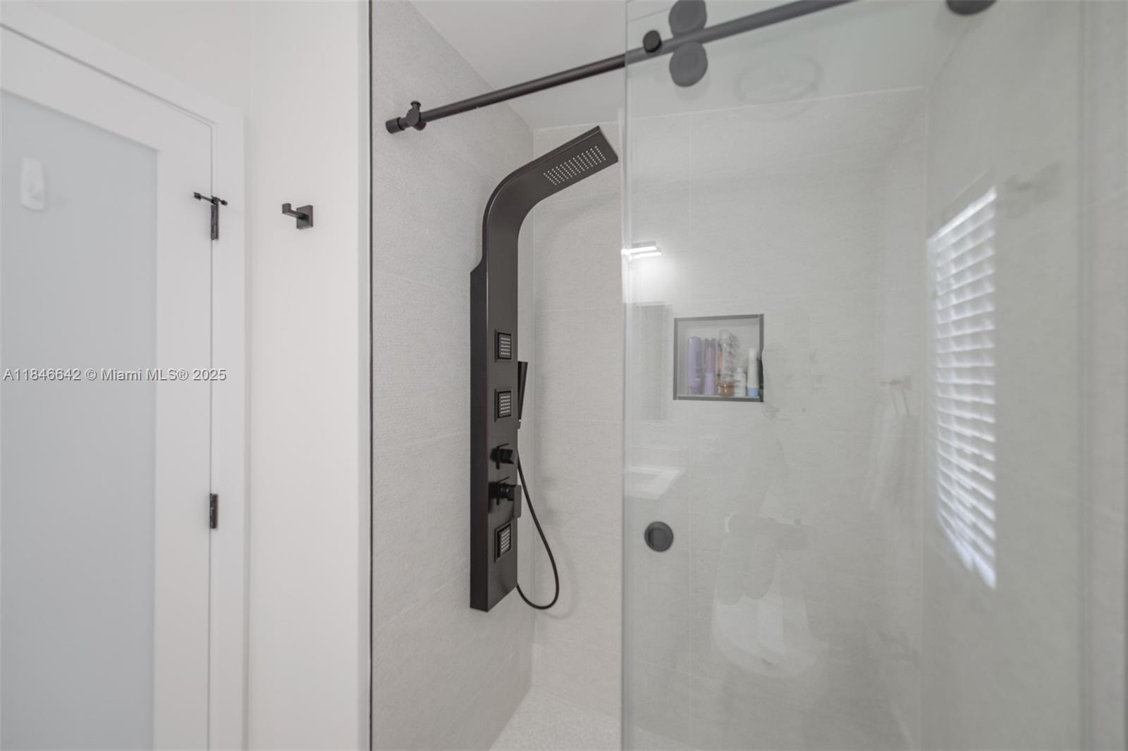 11 Mockingbird Road Key Largo, FL 33037 - Photo 27 of 44 a bathroom with a glass shower door