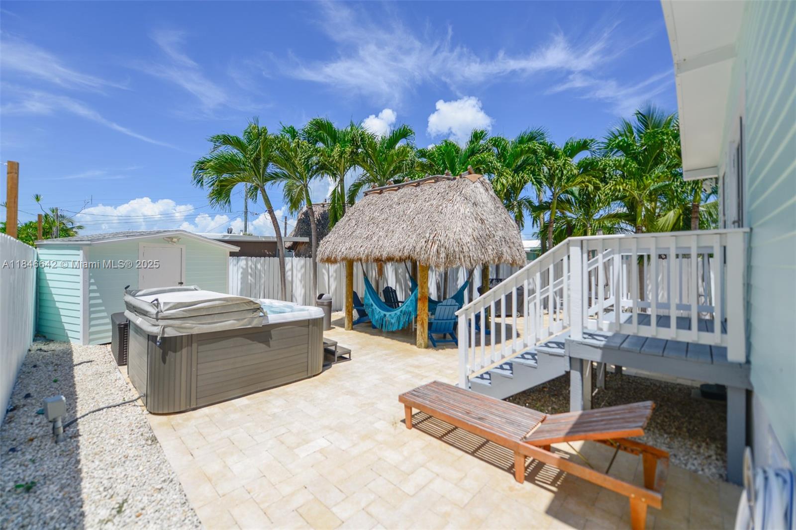 11 Mockingbird Road Key Largo, FL 33037 - Photo 28 of 44 a view of a chair and tables in the patio
