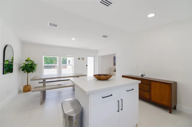 a kitchen with stainless steel appliances a refrigerator sink and stove