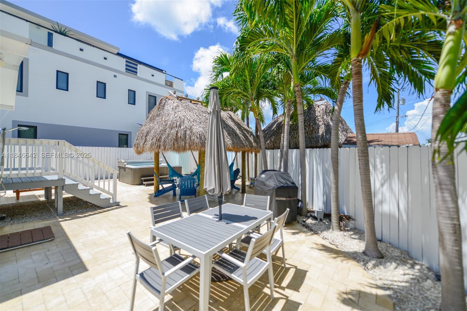 11 Mockingbird Road Key Largo, FL 33037 - Photo 32 of 44 a view of a dinning table and chairs in patio