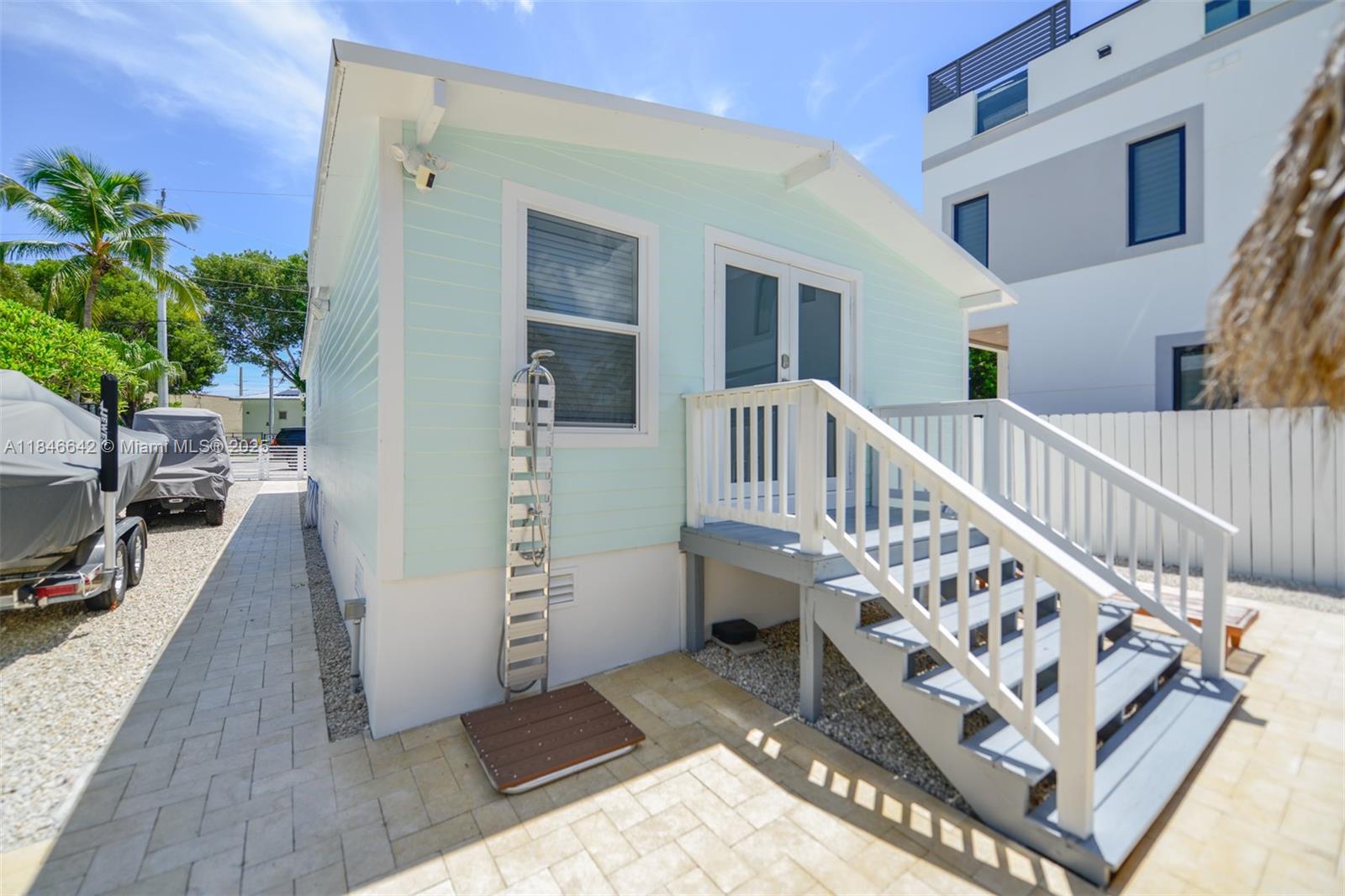 11 Mockingbird Road Key Largo, FL 33037 - Photo 33 of 44 a view of an entryway with wooden floor and a potted plant