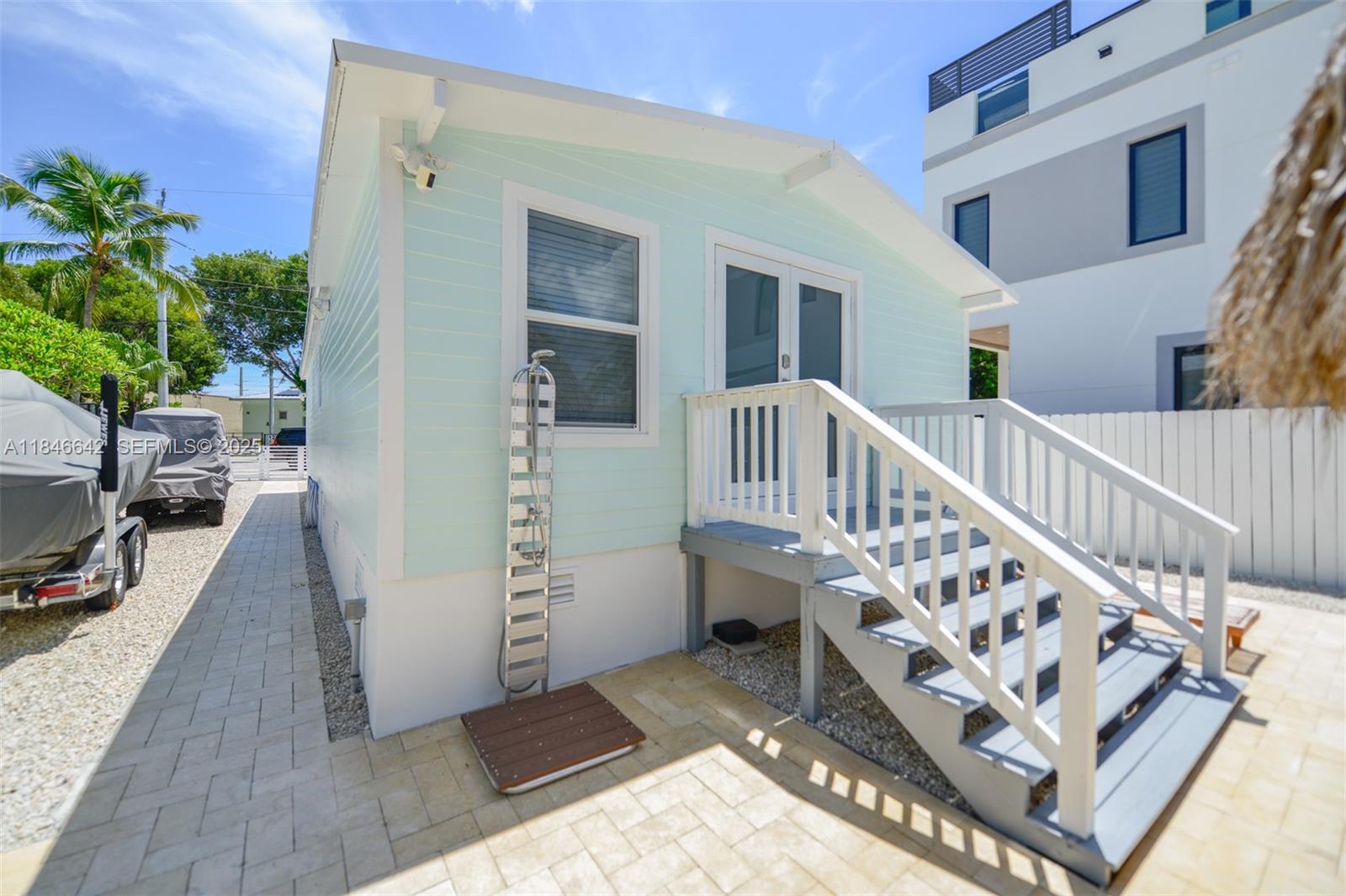 11 Mockingbird Road Key Largo, FL 33037 - Photo 33 of 44 a view of an entryway with wooden floor and a potted plant