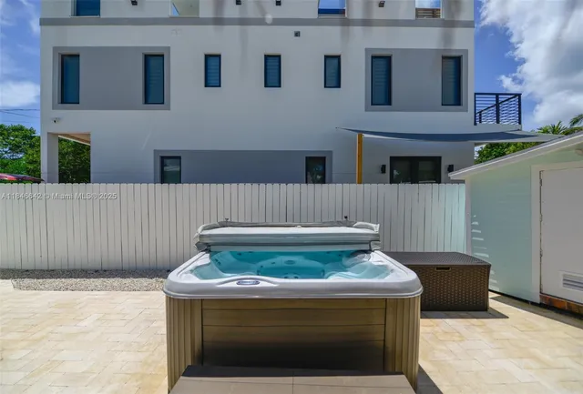 a backyard of a house with plants and tree