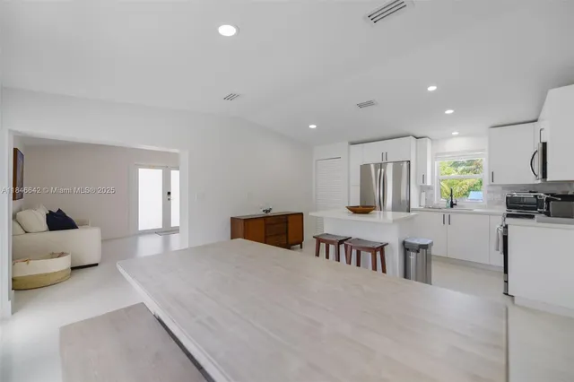 a kitchen with stainless steel appliances a refrigerator stove and microwave