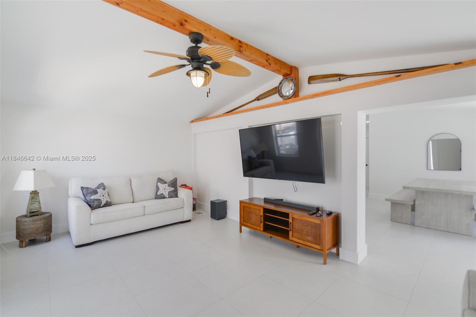 11 Mockingbird Road Key Largo, FL 33037 - Photo 10 of 44 a living room with furniture and a flat screen tv
