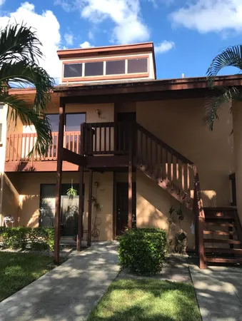 a view of house with a yard