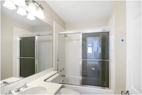a bathroom with a shower and a sink