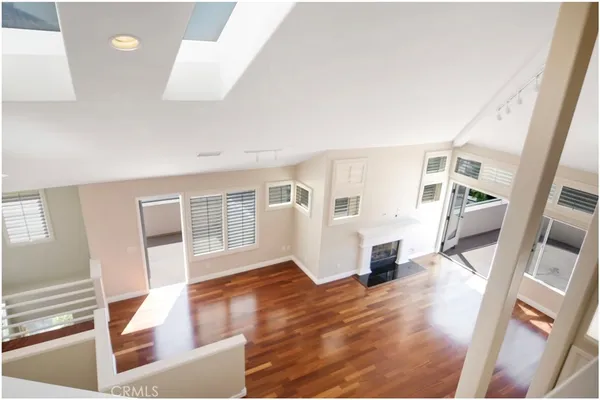 a view of a living room with furniture and wooden floor