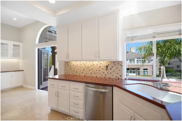 a kitchen with granite countertop a sink and a stove