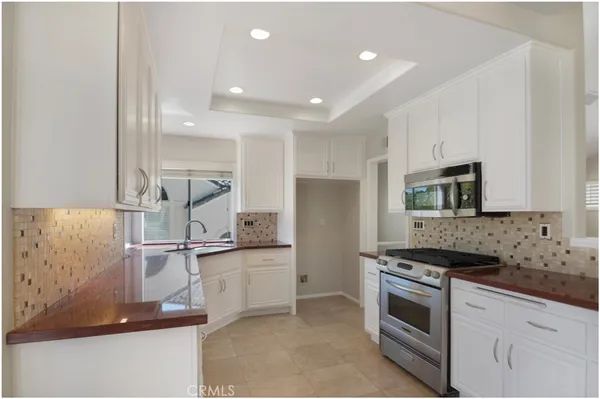 a kitchen with stainless steel appliances granite countertop a sink and a stove
