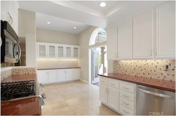 a kitchen with granite countertop a stove and a sink