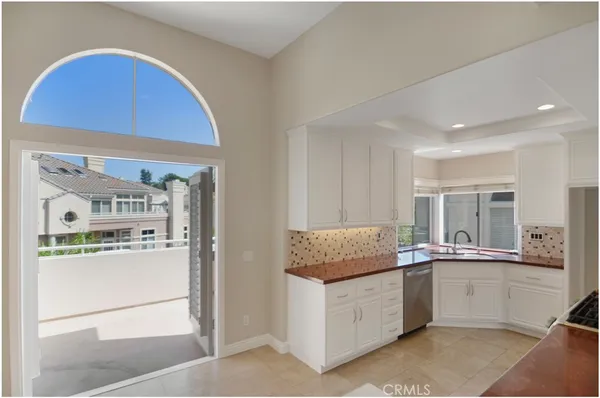 a kitchen with stainless steel appliances granite countertop a refrigerator and a stove