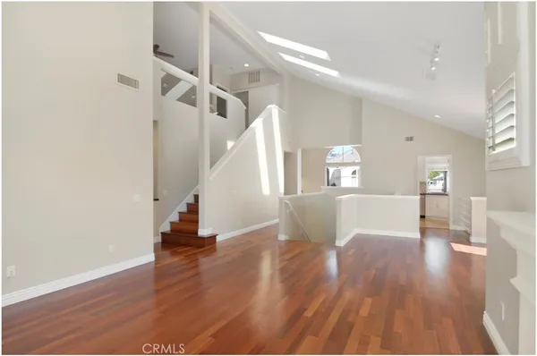 a view of a room with wooden floor and stairs