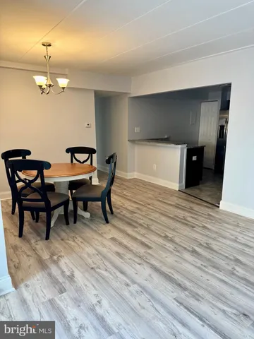 a kitchen with granite countertop a refrigerator and a stove top oven