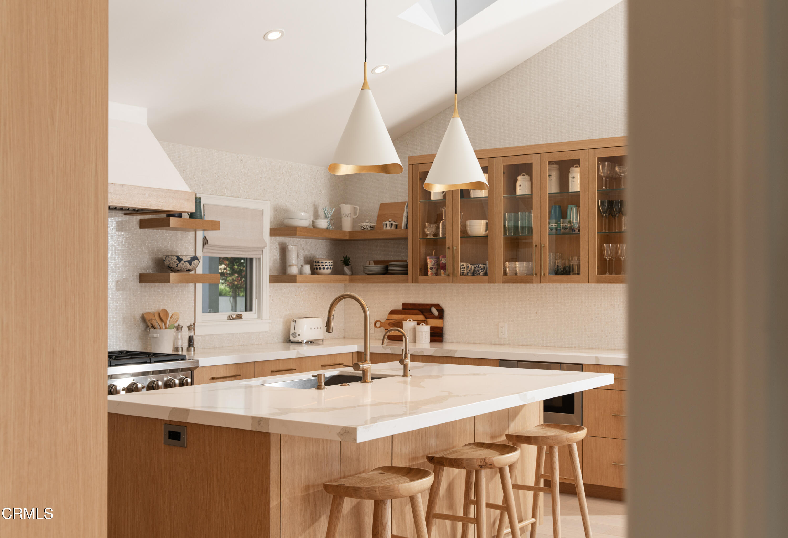 330 Salida Del Sol Santa Barbara, CA 93109 - Photo 11 of 39 a kitchen with a sink a counter and a dining table