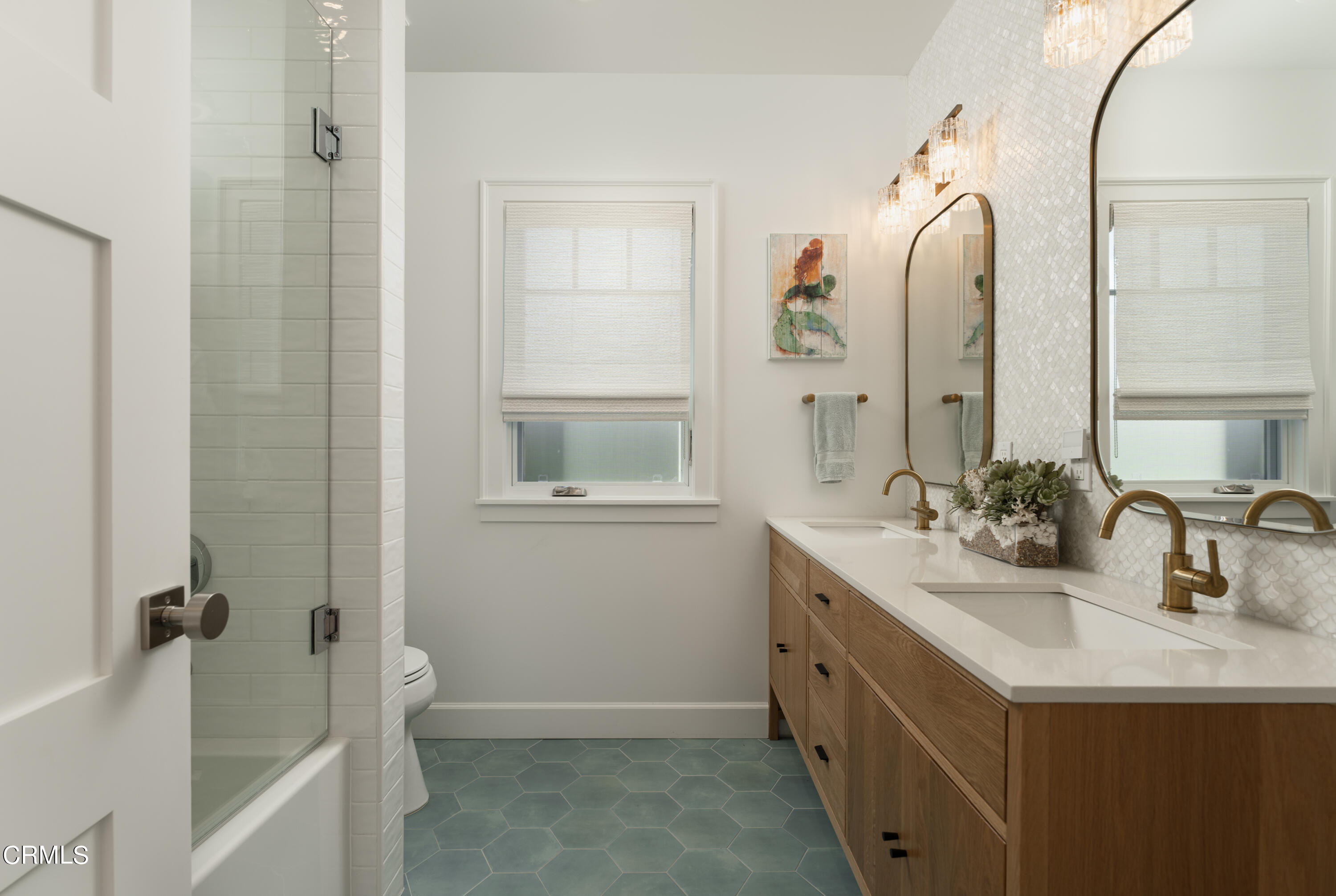 330 Salida Del Sol Santa Barbara, CA 93109 - Photo 29 of 39 a bathroom with a double vanity sink a mirror and a bathtub