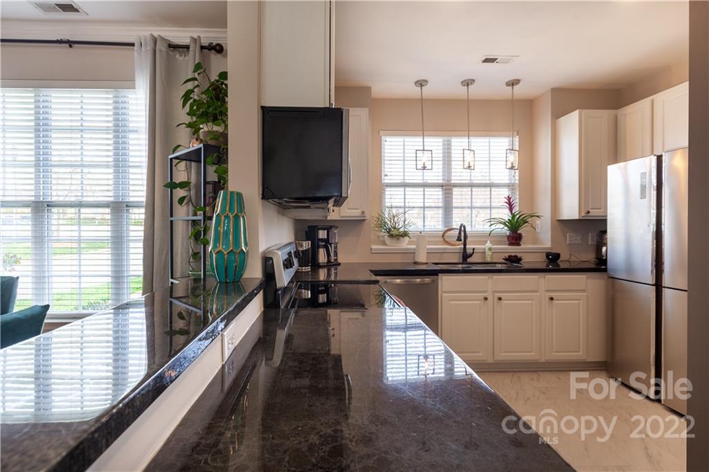 206 Dawn Mist Lane, Unit 28 Fort Mill, SC 29708 - Photo 11 of 39 a kitchen with stainless steel appliances a refrigerator sink and wooden floor