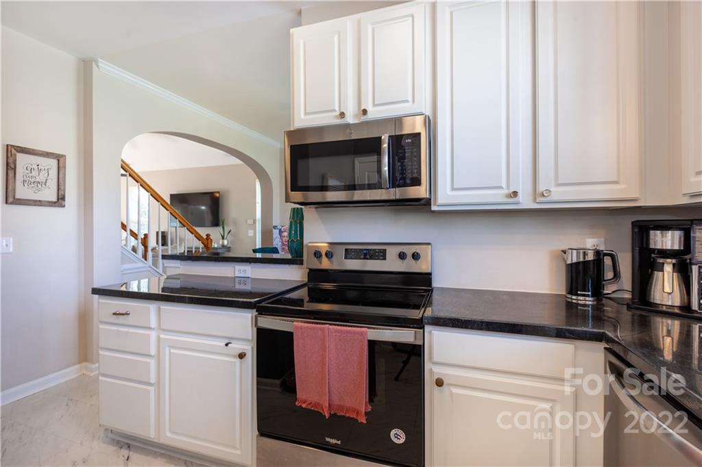 206 Dawn Mist Lane, Unit 28 Fort Mill, SC 29708 - Photo 14 of 39 a kitchen with stainless steel appliances granite countertop a stove a sink and a microwave