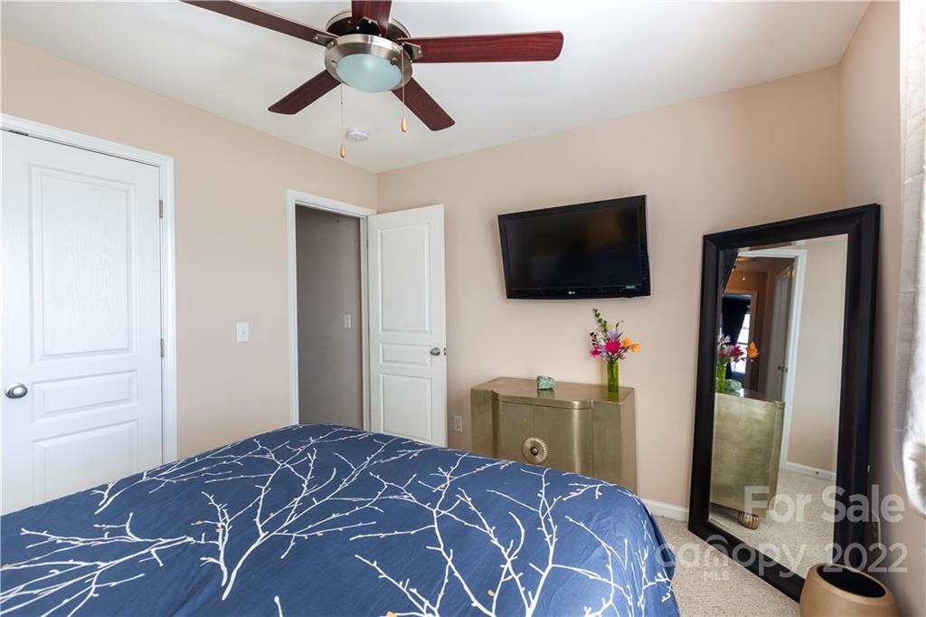 206 Dawn Mist Lane, Unit 28 Fort Mill, SC 29708 - Photo 27 of 39 a bedroom with a bed and a flat screen tv