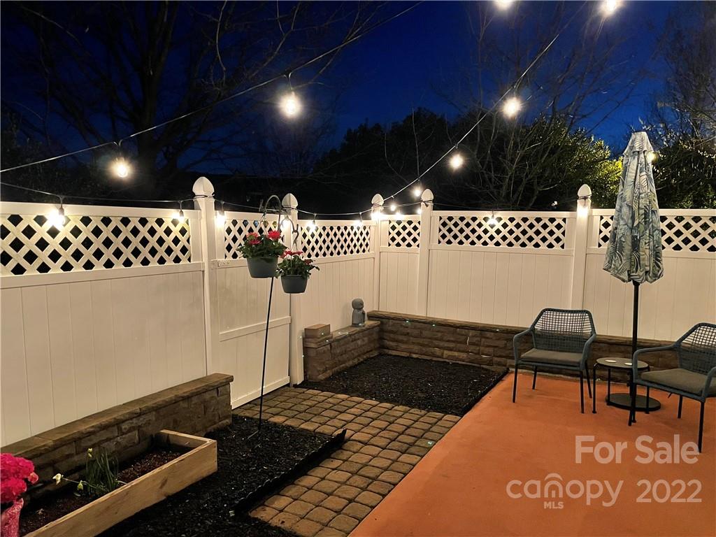 206 Dawn Mist Lane, Unit 28 Fort Mill, SC 29708 - Photo 3 of 39 a backyard of a house with table and chairs