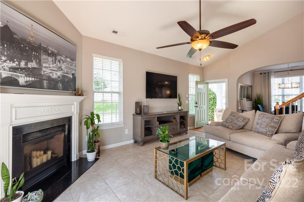 206 Dawn Mist Lane, Unit 28 Fort Mill, SC 29708 - Photo 6 of 39 a living room with furniture a flat screen tv and a fireplace