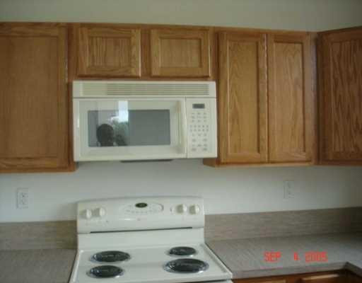 3237 Laurel Ridge Circle, Unit 3237 Riviera Beach, FL 33404 - Photo 3 of 4 a kitchen with a stove and cabinets
