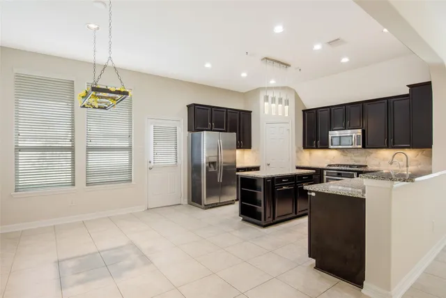 an empty room with closet and a chandelier fan