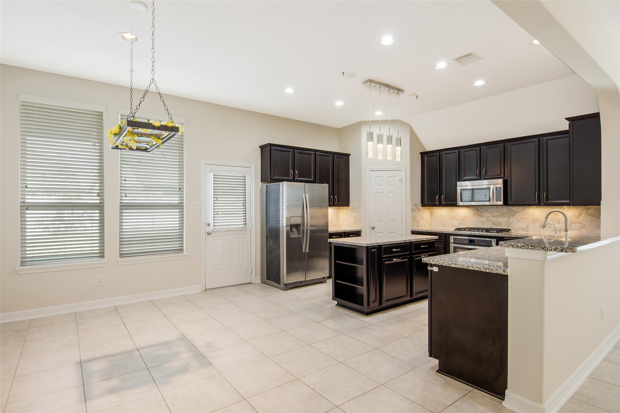 19906 Durwood Pines Lane Cypress, TX 77433 - Photo 10 of 26 a kitchen with stainless steel appliances granite countertop a refrigerator a stove a sink and a microwave