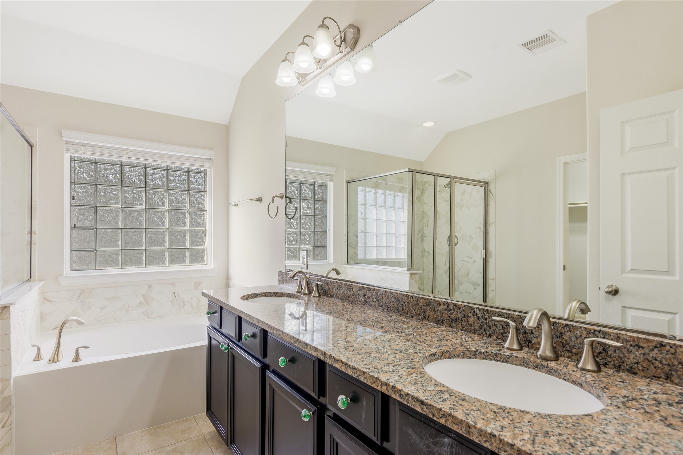 19906 Durwood Pines Lane Cypress, TX 77433 - Photo 13 of 26 a bathroom with a granite countertop sink a large mirror and a bathtub