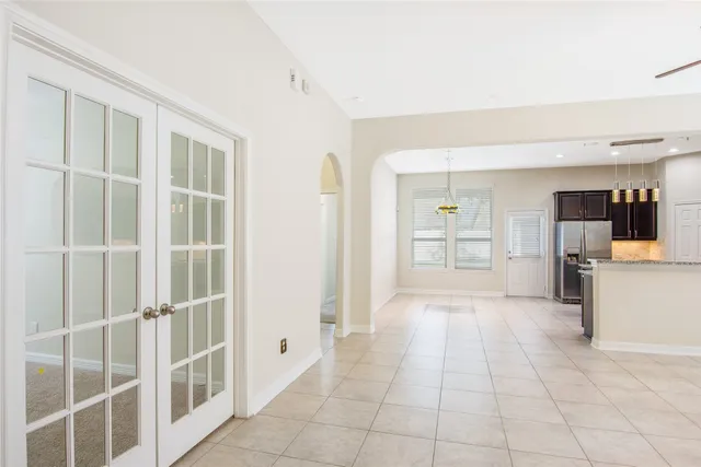 a view of a entryway with kitchen and windows