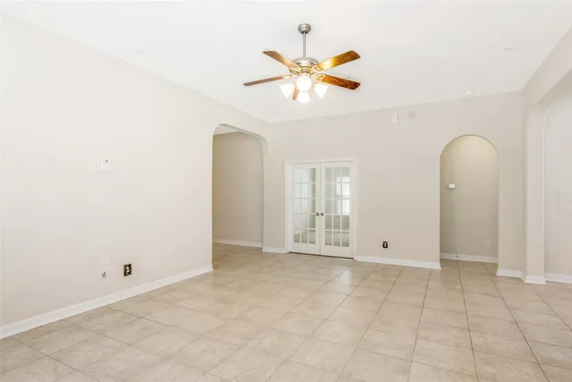 an empty room with windows and fireplace